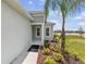 A welcoming entrance with a covered porch and a view of the lush landscaping at 4406 Rustling Pines Ter, Parrish, FL 34219