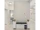 Hallway has an accent bench with storage space and an overhead light fixture at 4406 Rustling Pines Ter, Parrish, FL 34219
