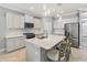 Modern kitchen featuring stainless steel appliances, a center island with seating, and sleek countertops at 4406 Rustling Pines Ter, Parrish, FL 34219