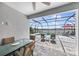 Covered patio with a view of a screened-in pool and the lake at 4406 Rustling Pines Ter, Parrish, FL 34219