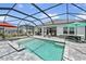 This open pool is surrounded by lounge chairs and covered and screened patio areas at 4406 Rustling Pines Ter, Parrish, FL 34219