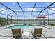 Inviting screened-in pool area with lake views, lounge chairs, and ample space for relaxation and outdoor living at 4406 Rustling Pines Ter, Parrish, FL 34219