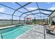 Inviting screened-in pool area with comfortable seating and lake views at 4406 Rustling Pines Ter, Parrish, FL 34219