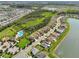 Aerial view showing neighborhood homes with water views, a community pool, and lush green landscaping at 4503 Lindever Ln, Palmetto, FL 34221