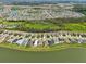 Expansive aerial view of a neighborhood with multiple homes, community pool, and surrounding lakes at 4503 Lindever Ln, Palmetto, FL 34221