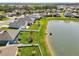 A tranquil backyard on the water with a white fence, featuring a well-maintained lawn, and direct water access at 4503 Lindever Ln, Palmetto, FL 34221