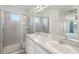 This bathroom features a double sink vanity, large mirror and a walk-in shower at 4503 Lindever Ln, Palmetto, FL 34221