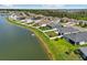 A picturesque home on a lakefront property, featuring lush green lawns and white picket fences at 4503 Lindever Ln, Palmetto, FL 34221