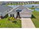 Well-maintained home with an attached two-car garage, a manicured lawn, and lush landscaping at 4503 Lindever Ln, Palmetto, FL 34221