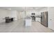 Modern kitchen with stainless steel appliances, white cabinetry, and granite countertops at 4503 Lindever Ln, Palmetto, FL 34221