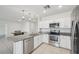 Bright kitchen featuring stainless steel appliances, granite countertops, and modern pendant lighting at 4503 Lindever Ln, Palmetto, FL 34221