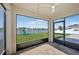 Relaxing screened lanai with ceiling fan offers views of the yard, lake, and playground set at 4503 Lindever Ln, Palmetto, FL 34221