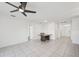 Spacious living room with neutral tile flooring, fan, and access to other areas of the home at 4503 Lindever Ln, Palmetto, FL 34221