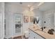 Bathroom featuring a single vanity and direct backyard access at 4505 Camino Real, Sarasota, FL 34231