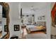 Bright bedroom features hardwood floors, a ceiling fan, and access to natural light at 4505 Camino Real, Sarasota, FL 34231