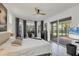 Bedroom with dark accent curtains and outdoor access at 4505 Camino Real, Sarasota, FL 34231