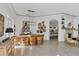Spacious dining area features a wooden table, statement art, and an open view to the kitchen at 4505 Camino Real, Sarasota, FL 34231