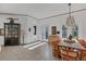 Dining room showcasing a wooden table, hutch, tile floors, and sunlit french doors at 4505 Camino Real, Sarasota, FL 34231