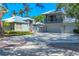 Stunning two-story home with a balcony, spacious garage and lush tropical landscaping at 4505 Camino Real, Sarasota, FL 34231