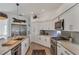 Well-lit kitchen featuring stainless steel appliances, white cabinets, and an island at 4505 Camino Real, Sarasota, FL 34231