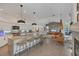 Open kitchen featuring an island with bar seating and stylish pendant lighting at 4505 Camino Real, Sarasota, FL 34231