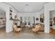Open living room with fireplace, decor, seating area, and an abundance of natural light at 4505 Camino Real, Sarasota, FL 34231