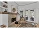 Living room featuring a cozy chair next to a stone fireplace, decor and tile flooring at 4505 Camino Real, Sarasota, FL 34231