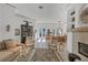 Bright living room with fireplace, seating, decor and views to the backyard at 4505 Camino Real, Sarasota, FL 34231
