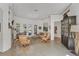 Bright living room with tile floors, large windows, and elegant decor and stone fireplace at 4505 Camino Real, Sarasota, FL 34231