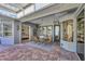Inviting patio with brick flooring, dining area, and multiple doors providing ample natural light at 4505 Camino Real, Sarasota, FL 34231