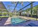 Screened-in pool with brick surround offers a relaxing retreat amidst lush landscaping and sunny skies at 4505 Camino Real, Sarasota, FL 34231