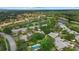 An aerial view of a community with golf course, pond, and lush landscaping at 4505 Kingsmere # 2, Sarasota, FL 34235