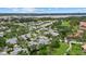An aerial view of the community showcasing lush landscaping, community pool and beautiful waterways at 4505 Kingsmere # 2, Sarasota, FL 34235
