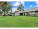 A well-maintained lawn and mature trees offer privacy and charm to this beautiful property's exterior at 4505 Kingsmere # 2, Sarasota, FL 34235