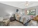 Cozy bedroom with large window, soft lighting, and comfortable furnishings at 4505 Kingsmere # 2, Sarasota, FL 34235