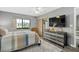 Well-lit bedroom featuring a dresser, TV, and large window with backyard views at 4505 Kingsmere # 2, Sarasota, FL 34235