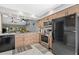 Well-equipped kitchen featuring stainless steel appliances, granite countertops, and modern wood cabinetry at 4505 Kingsmere # 2, Sarasota, FL 34235