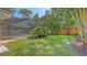 Spacious backyard with lush greenery and a screened pool, perfect for outdoor relaxation and entertainment at 4665 Pine Harrier Dr, Sarasota, FL 34231