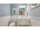 This charming bathroom features a stylish vanity with storage, wainscoting, and a neutral color palette at 4665 Pine Harrier Dr, Sarasota, FL 34231