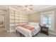 This bedroom features soft carpeting, a large built-in bookshelf, and a bright window overlooking the yard at 4665 Pine Harrier Dr, Sarasota, FL 34231