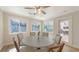 Bright breakfast nook with a round table, six chairs, and views of the lush backyard at 4665 Pine Harrier Dr, Sarasota, FL 34231