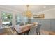 Dining room features a rustic wood table with seating for six and a modern chandelier at 4665 Pine Harrier Dr, Sarasota, FL 34231