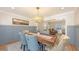 Dining room with custom wainscoting, a rustic wood table, and a decorative chandelier at 4665 Pine Harrier Dr, Sarasota, FL 34231