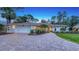 Beautiful home with lush landscaping, paver driveway, and a well-manicured lawn at 4665 Pine Harrier Dr, Sarasota, FL 34231