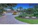 Well-maintained home featuring a paver driveway, mature landscaping, and a two-car garage at 4665 Pine Harrier Dr, Sarasota, FL 34231