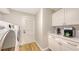 Well-appointed laundry room with modern appliances, custom cabinetry, and bright, natural light at 4665 Pine Harrier Dr, Sarasota, FL 34231