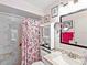 Bathroom with a white marble shower, modern fixtures, and decorative pink floral shower curtain at 4869 Village Gardens Dr # 189, Sarasota, FL 34234