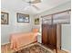 Cozy bedroom with wood floors, a ceiling fan, a single bed, and a dark wood armoire for storage at 4869 Village Gardens Dr # 189, Sarasota, FL 34234