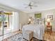 Charming bedroom features a sliding glass door, ceiling fan, neutral colors, and comfortable furnishings for a restful retreat at 4869 Village Gardens Dr # 189, Sarasota, FL 34234