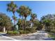 Welcoming entrance to Village Gardens with lush landscaping and a clear community sign at 4869 Village Gardens Dr # 189, Sarasota, FL 34234